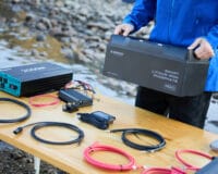 A table with a lithium battery, cables and other Renogy products
