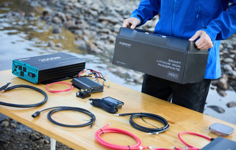 A table with a lithium battery, cables and other Renogy products
