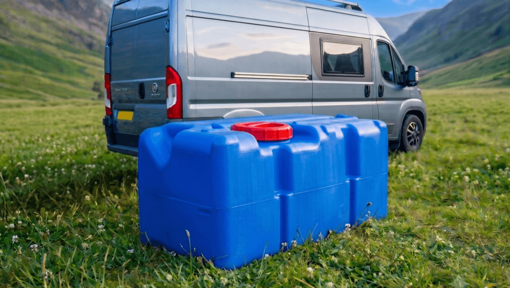 Fiat Ducato motorhome in a field with a water tank in front of it