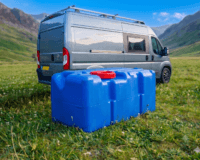 Fiat Ducato motorhome in a field with a water tank in front of it